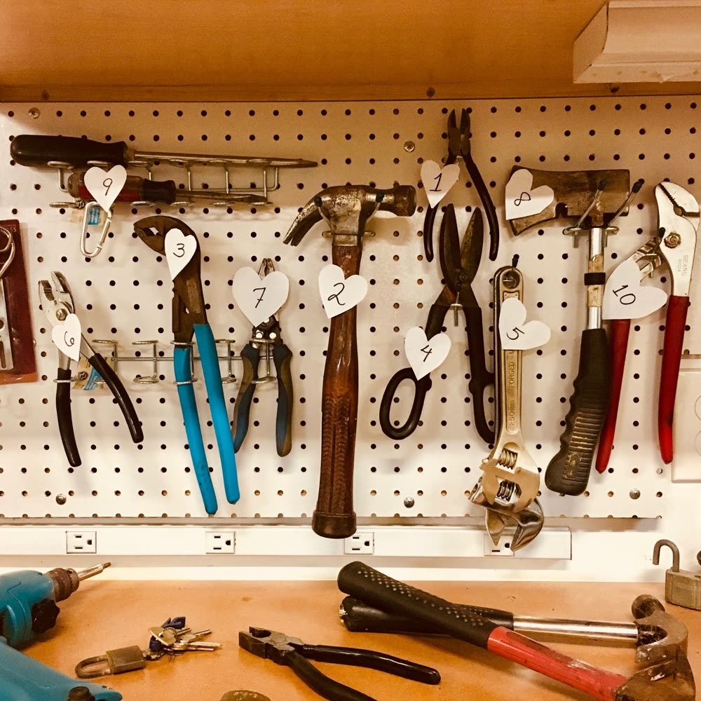A pegboard of neatly organised hand tools — the right tool for every task